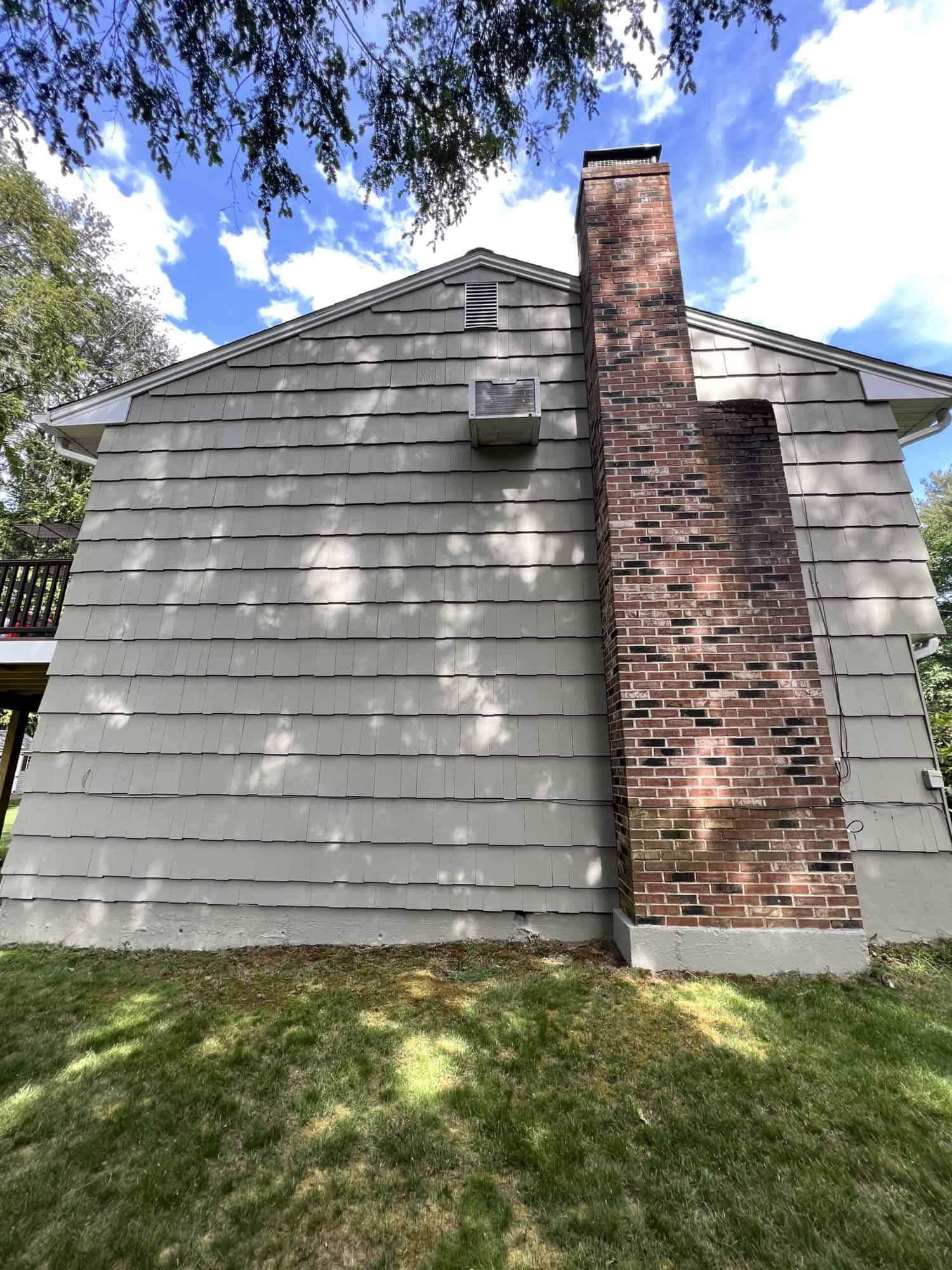 exterior of a house with a brick chimney after high pressure cleaning